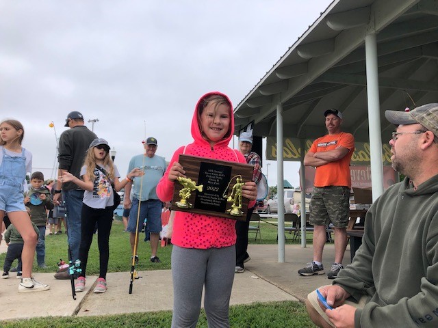 Photo of fishing derby contestant with reward