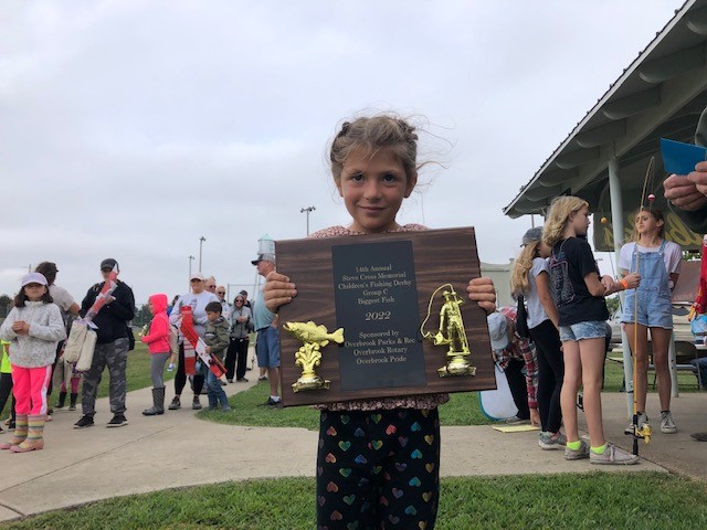 Photo of fishing derby contestant with award