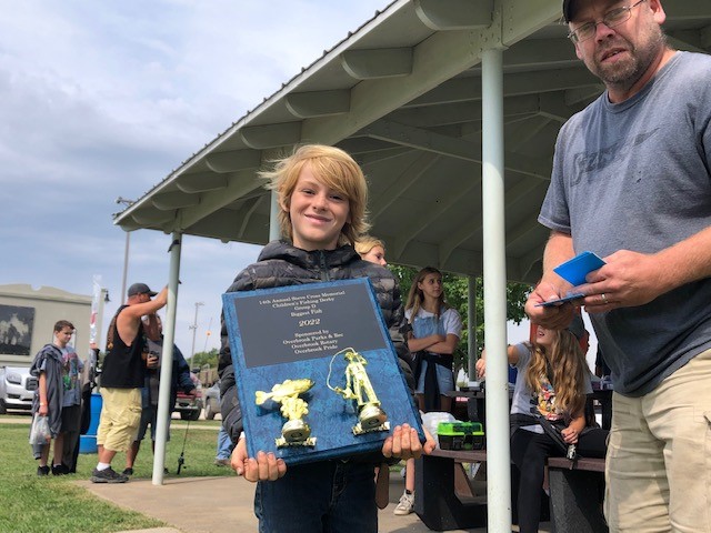 Photo of fishing derby contestant with award