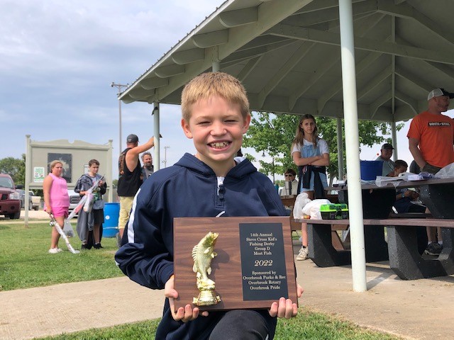 Photo of fishing derby contestant with award
