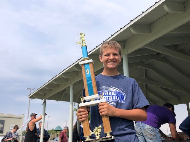 Photo of fishing derby contestant with trophy