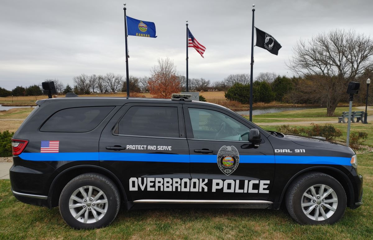 Photo of Police Car in front of flags