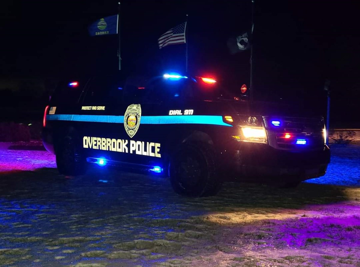Photo of police car with lights on at night